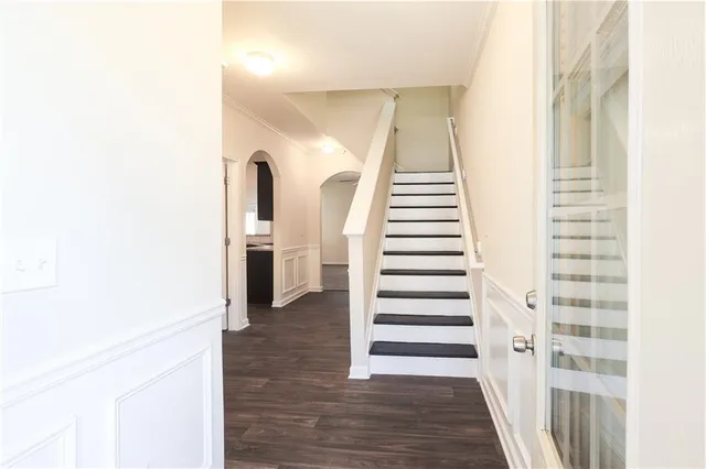 a view of a hallway with wooden floor and entryway