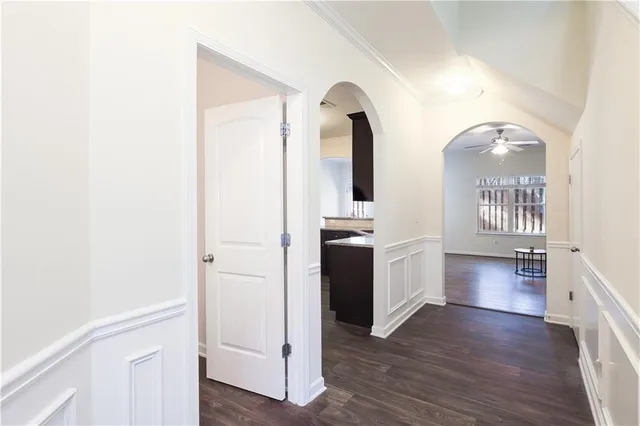a view of entryway and kitchen with wooden floor