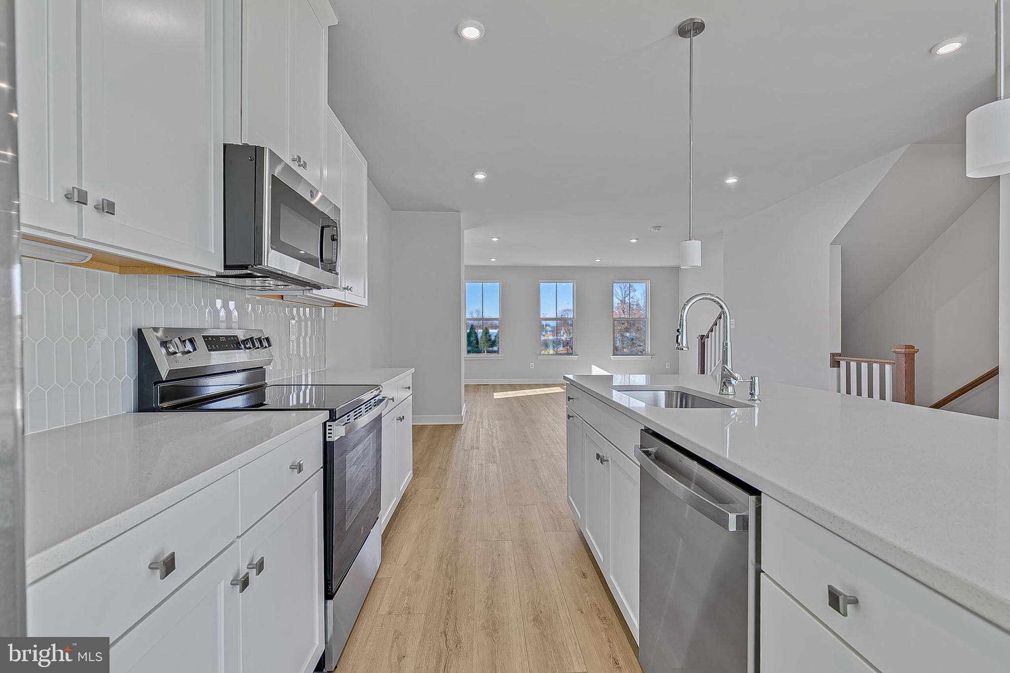 1 B Oasis Avenue Ranson, WV 25438 - Photo 12 of 39 a kitchen with stainless steel appliances granite countertop a sink a stove and a refrigerator