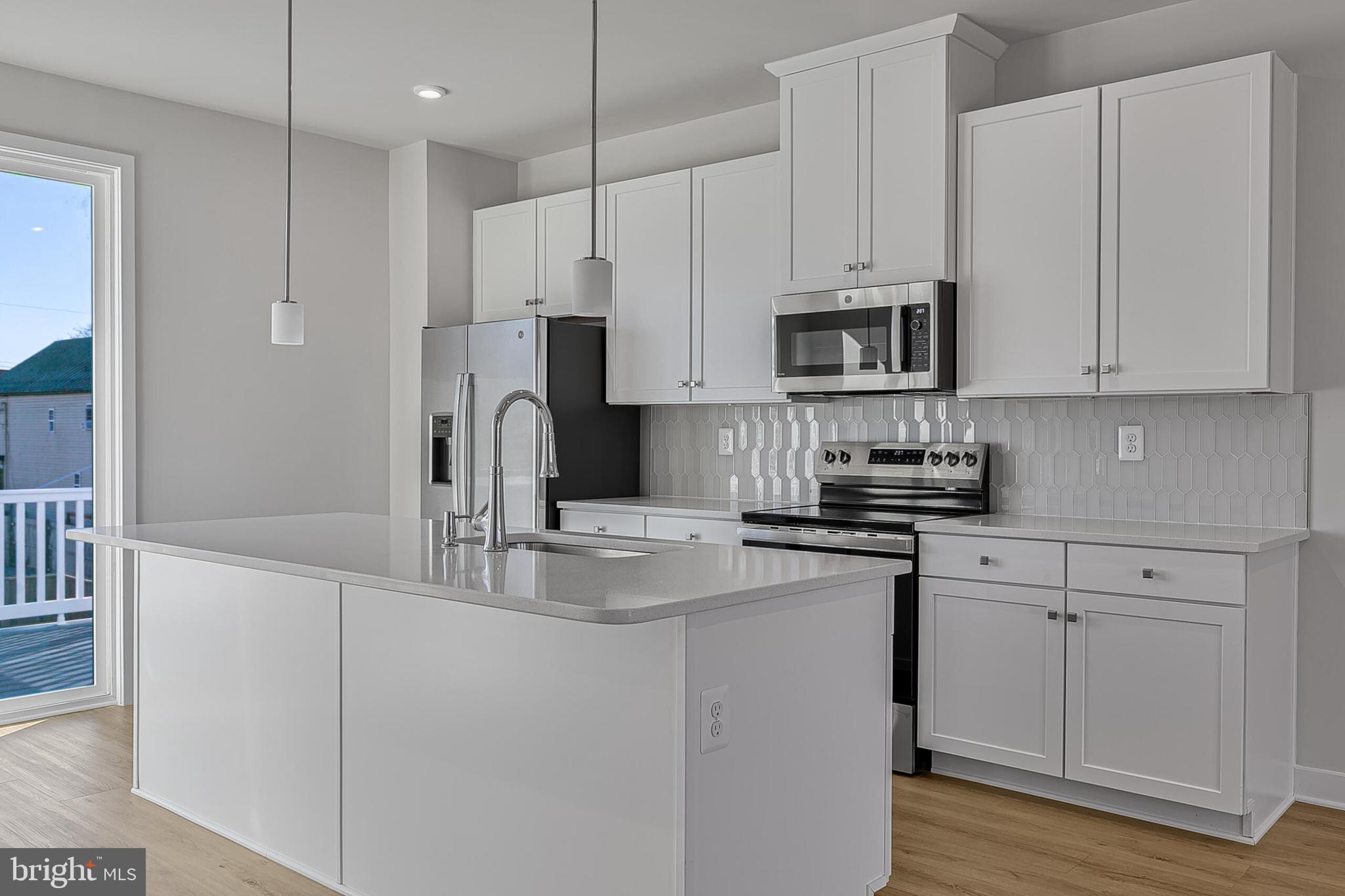 1 B Oasis Avenue Ranson, WV 25438 - Photo 17 of 39 a kitchen with stainless steel appliances granite countertop white cabinets a sink and a stove