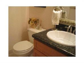 6115 Via Laguna Lane Boca Raton, FL 33433 - Photo 5 of 14 a bathroom with a granite countertop toilet and a sink