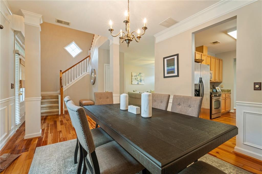 878 Scales Road Suwanee, GA 30024 - Photo 5 of 17 a view of a dining room with furniture and wooden floor