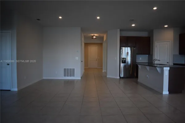 a view of a kitchen with refrigerator and outdoor space