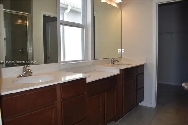 a bathroom with a double vanity sink and a mirror