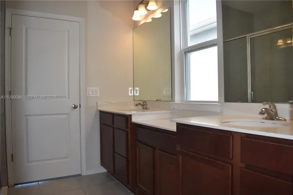 a bathroom with a double vanity sink and a mirror