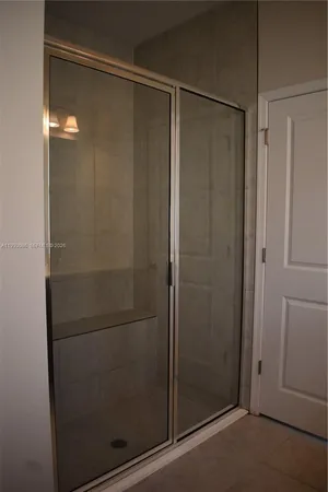 a bathroom with a glass shower door