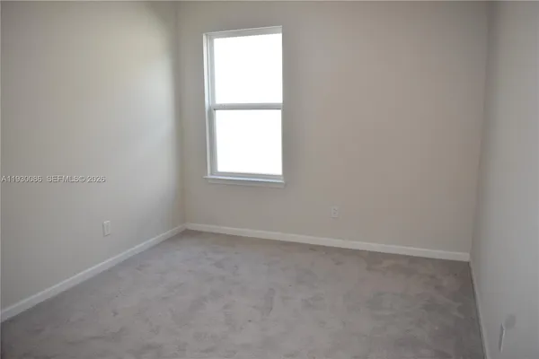 an empty room with closet area