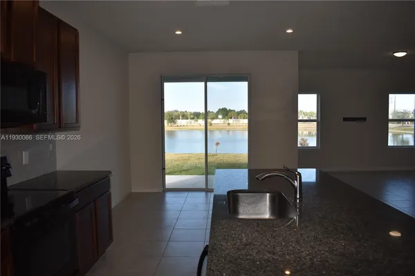 a kitchen with granite countertop a stove a sink and a granite counter top