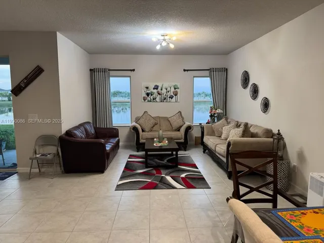 a living room with furniture gym equipment and a large window