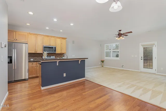 a kitchen with kitchen island sink refrigerator and stove