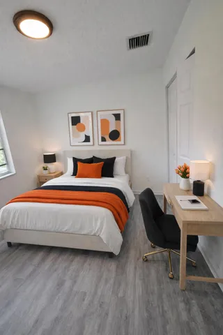 a bedroom with a bed and a workspace