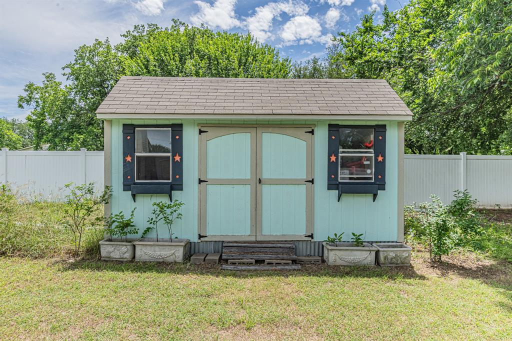 204 Spring Branch Trail South Springtown, TX 76082 - Photo 35 of 39 Light blue storage shed with double arched doors