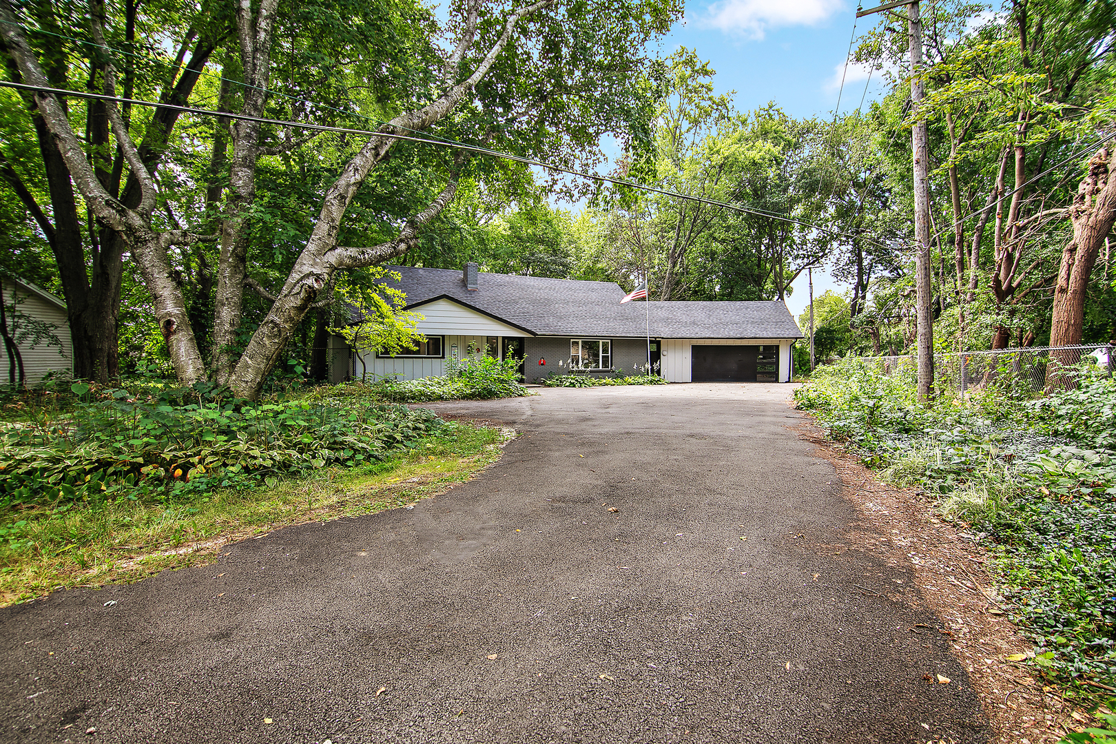 22 Erin Lane Kankakee, IL 60901 - Photo 2 of 45 a backyard of a house with plants and large trees