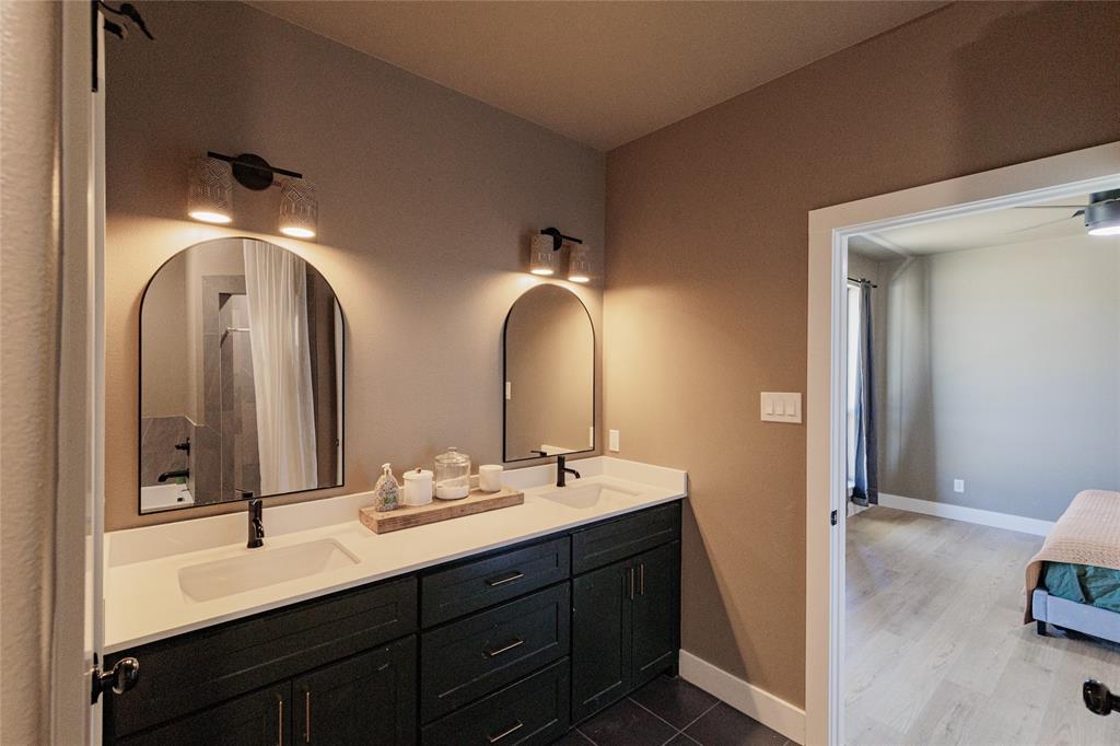 500 County Road 2745 Decatur, TX 76234 - Photo 22 of 38 a en suite bathroom with double vanity sinks and a mirror
