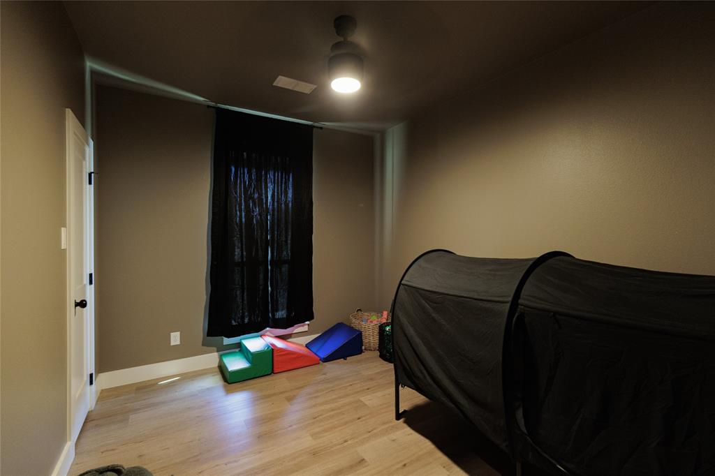 500 County Road 2745 Decatur, TX 76234 - Photo 27 of 38 a bedroom with a bed and wooden floor