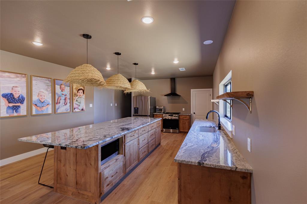 500 County Road 2745 Decatur, TX 76234 - Photo 9 of 38 a large kitchen with kitchen island a large island in it