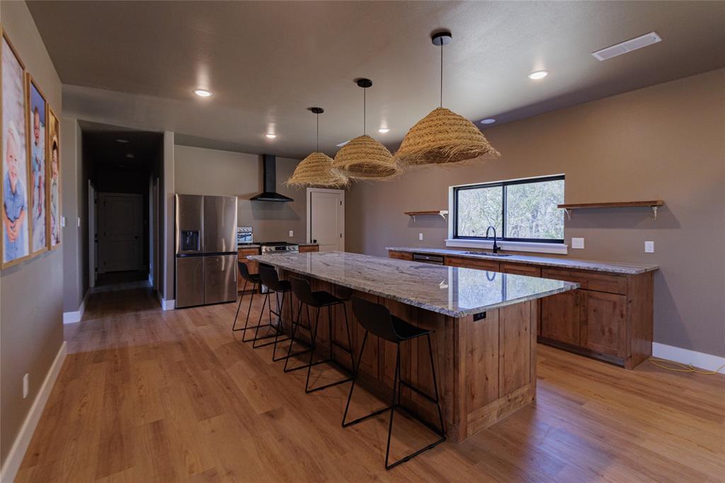 500 County Road 2745 Decatur, TX 76234 - Photo 10 of 38 a kitchen with stainless steel appliances granite countertop a kitchen island a stove and a wooden floors