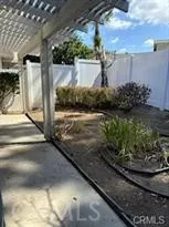 a view of a back yard of the house and cars parked
