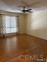 915 South Ridgecrest Circle Anaheim, CA 92807 - Photo 8 of 21 wooden floor in an empty room with a window