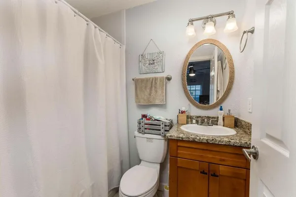 a bathroom with a toilet a sink and a mirror