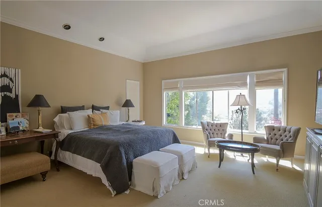 a bedroom with bed and a large window