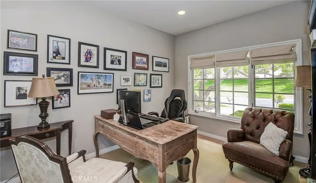 a living room with furniture a flat screen tv and a large window
