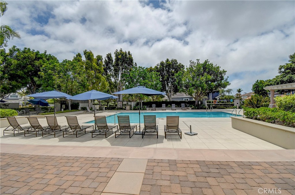 33 Hastings Laguna Niguel, CA 92677 - Photo 17 of 17 a view of a swimming pool with lawn chairs under an umbrella
