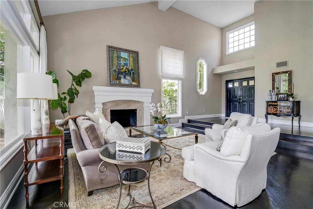 33 Hastings Laguna Niguel, CA 92677 - Photo 5 of 17 a living room with furniture a fireplace and a chandelier