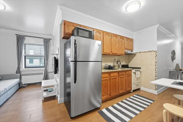 a kitchen with stainless steel appliances granite countertop a refrigerator and a sink