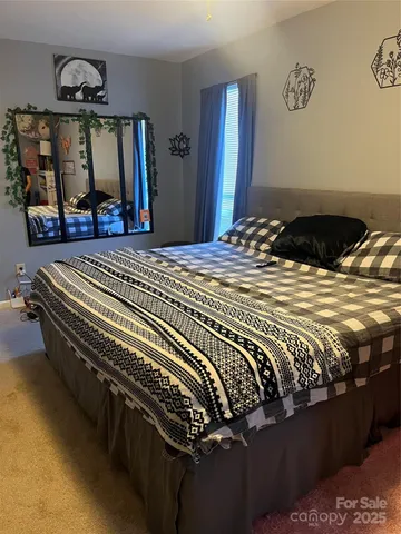 a bedroom with a bed and a mirror