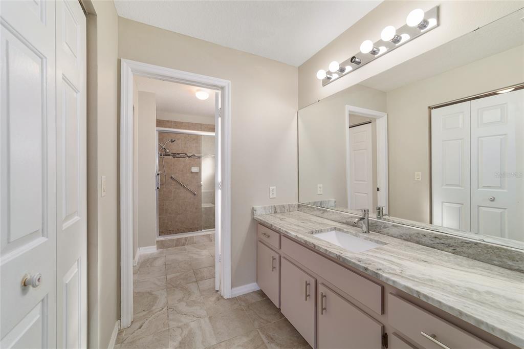6241 Southwest 84th Place Ocala, FL 34476 - Photo 18 of 33 a bathroom with double sink and a mirror