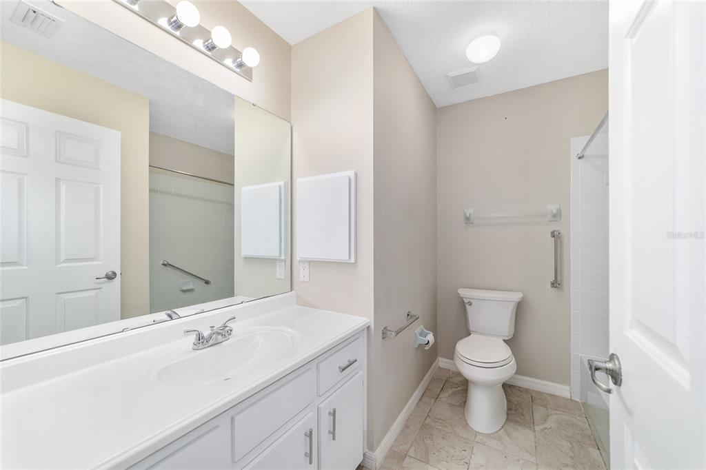 6241 Southwest 84th Place Ocala, FL 34476 - Photo 22 of 33 a bathroom with a toilet sink and mirror