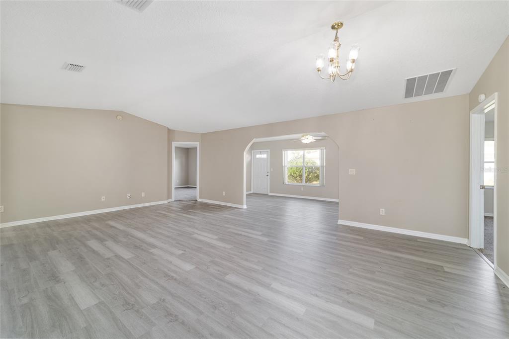 6241 Southwest 84th Place Ocala, FL 34476 - Photo 7 of 33 an empty room with wooden floor and window