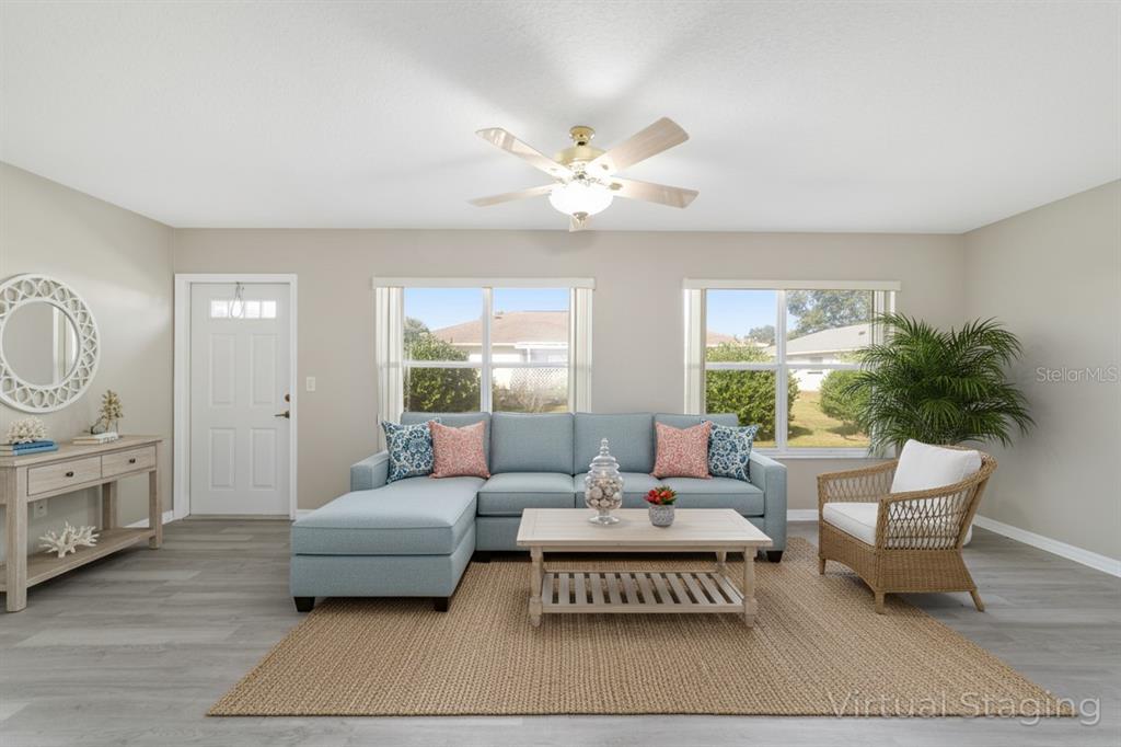 6241 Southwest 84th Place Ocala, FL 34476 - Photo 8 of 33 a living room with furniture a table and a potted plant