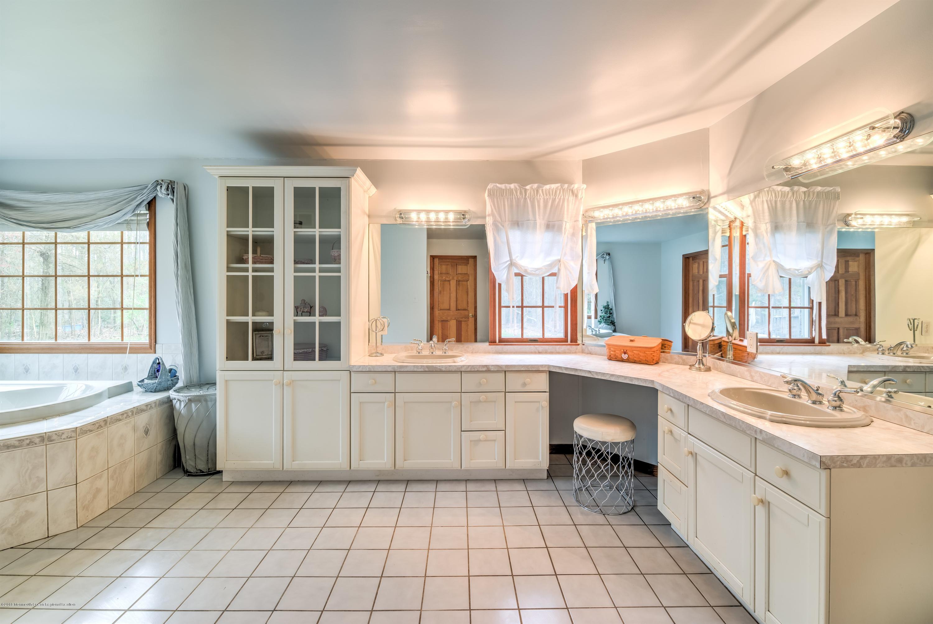 20 Hornerstown Road Cream Ridge, NJ 08514 - Photo 16 of 28 a large white bathroom with a sink a large mirror and bathtub