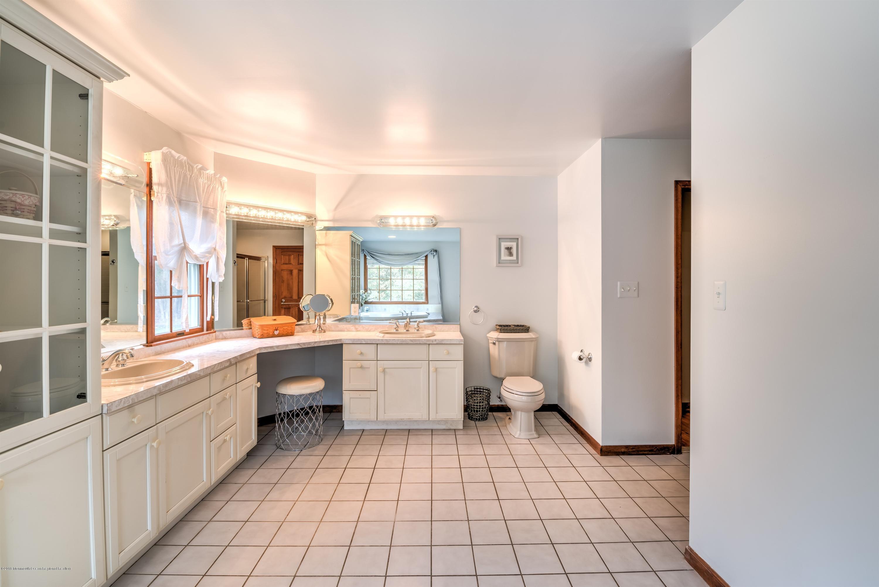 20 Hornerstown Road Cream Ridge, NJ 08514 - Photo 19 of 28 a large white bathroom with a granite countertop sink mirror and bathtub