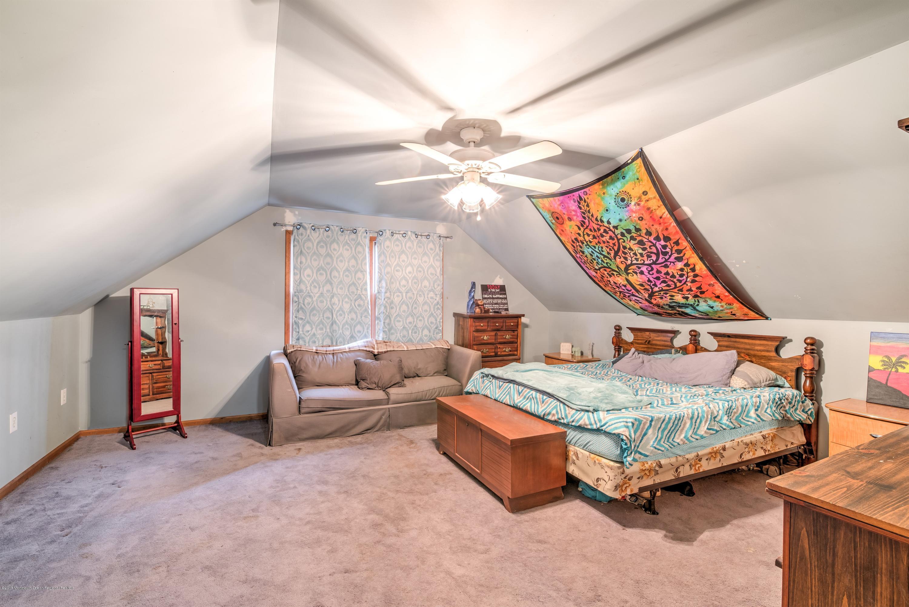 20 Hornerstown Road Cream Ridge, NJ 08514 - Photo 20 of 28 a bedroom with furniture and a chandelier