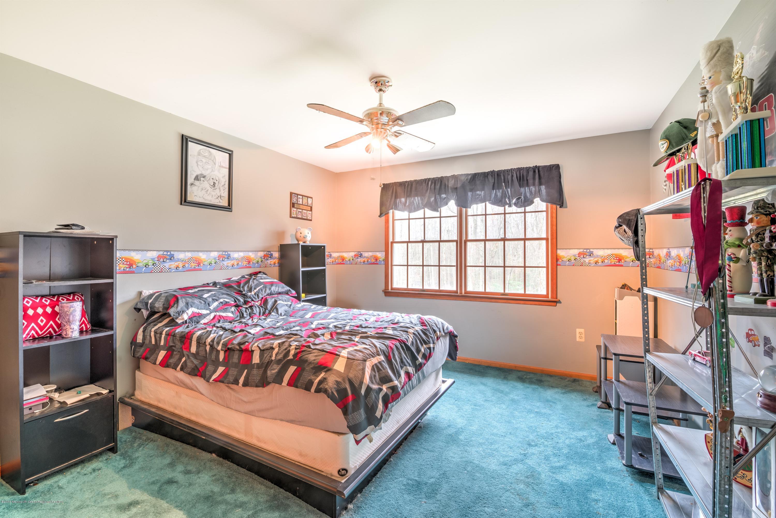 20 Hornerstown Road Cream Ridge, NJ 08514 - Photo 21 of 28 a bedroom with a bed and a chandelier