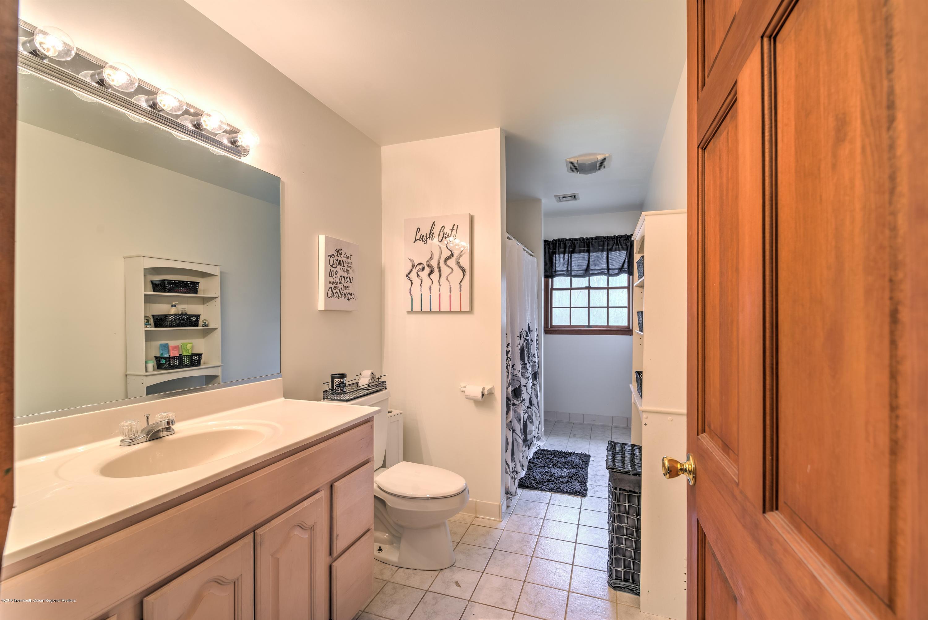 20 Hornerstown Road Cream Ridge, NJ 08514 - Photo 23 of 28 a bathroom with a granite countertop sink toilet and shower
