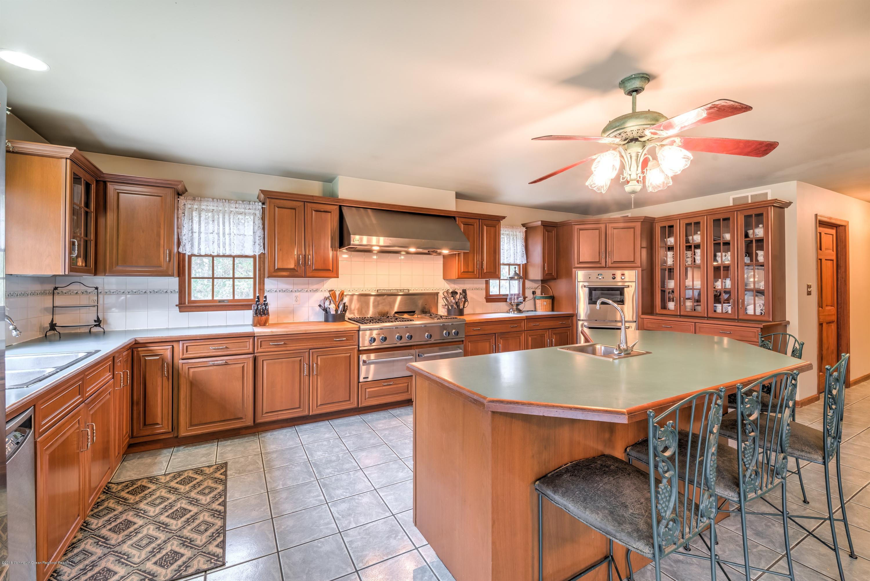 20 Hornerstown Road Cream Ridge, NJ 08514 - Photo 10 of 28 a large kitchen with kitchen island a island a stove a sink a dining table and chairs