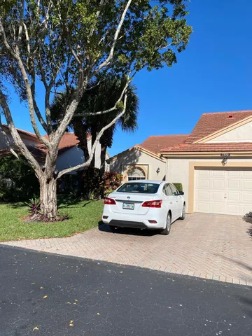 a view of a car parked in front of a house