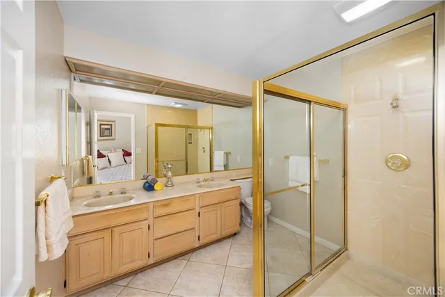 a spacious bathroom with a shower sink and mirror