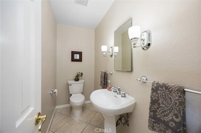 a bathroom with a sink mirror and toilet
