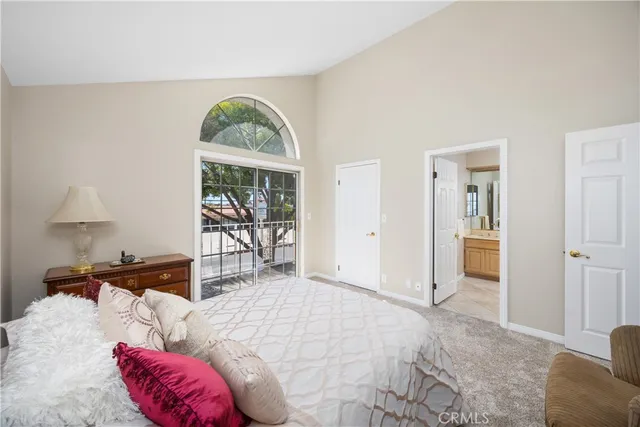 a bedroom with a large bed and a window