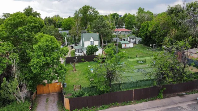 an aerial view of a house with a yard basket ball court and outdoor seating