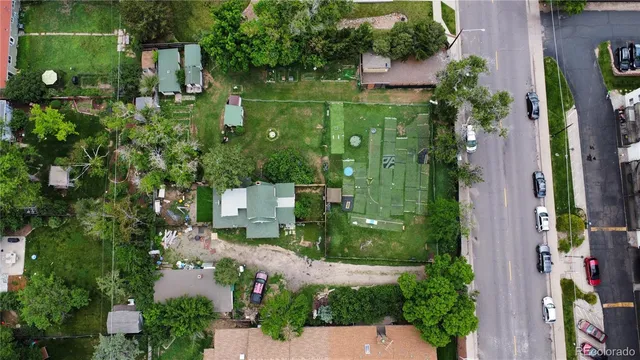 an aerial view of a house with a yard