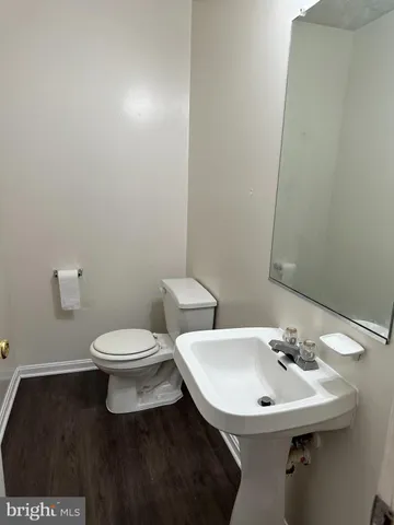 a white toilet sitting next to a bathroom sink