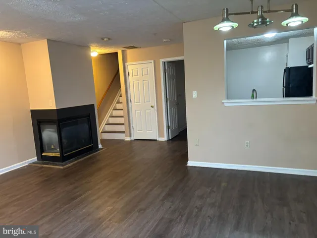 wooden floor in an empty room with a fireplace