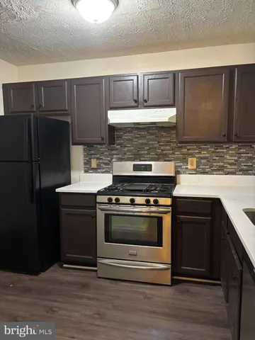 a kitchen with a sink stove and refrigerator