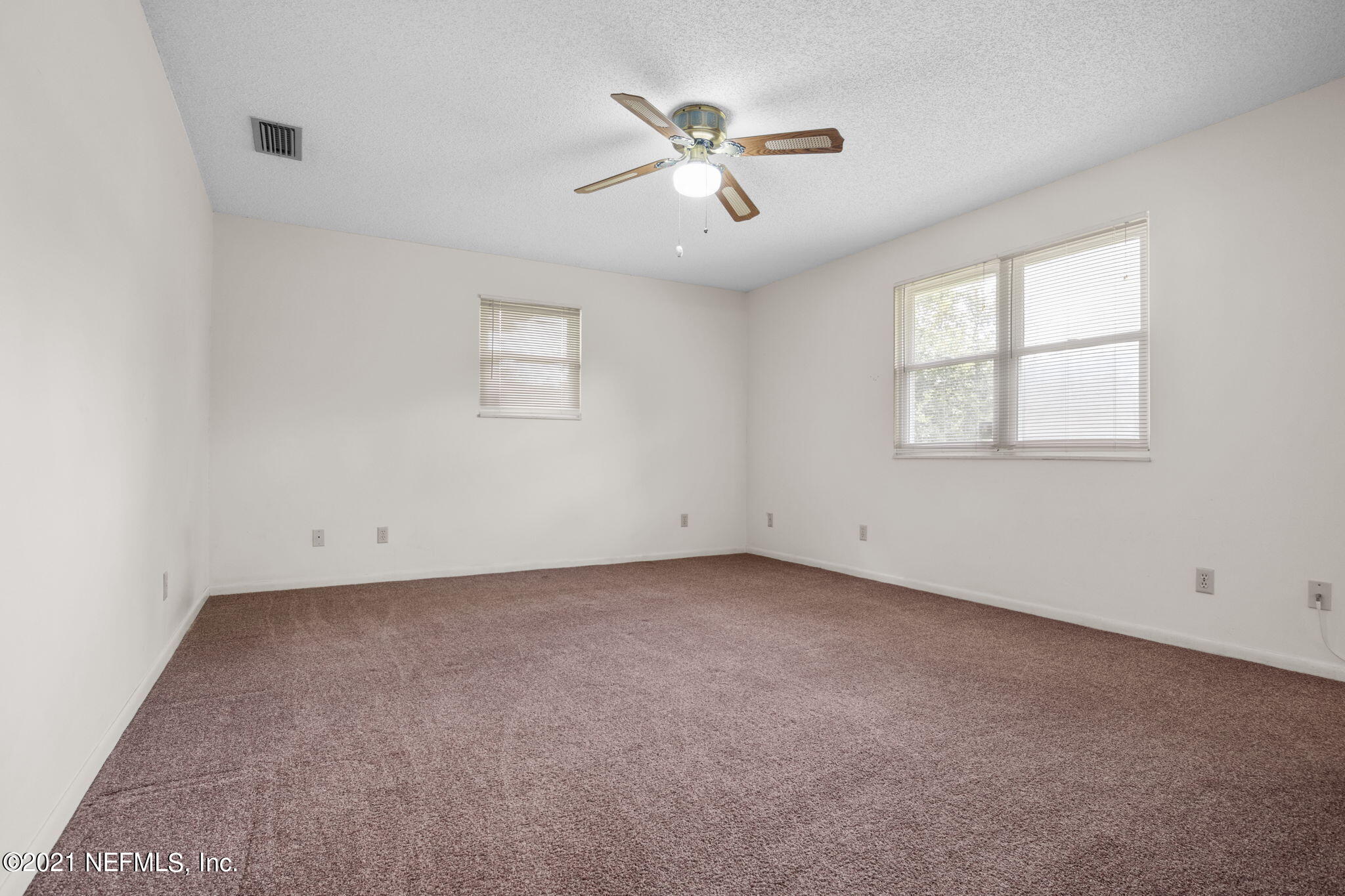 4730 Ricker Road Jacksonville, FL 32210 - Photo 15 of 30 an empty room with a window and a ceiling fan